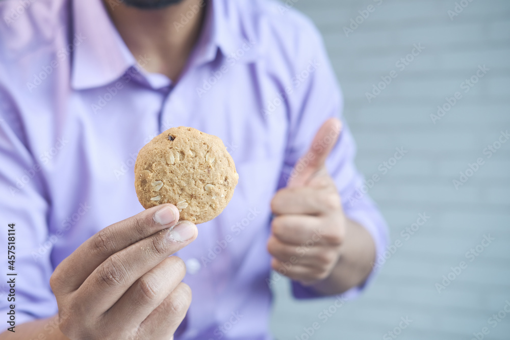 young man eating whole meal cookies young man eating whole meal cookies
