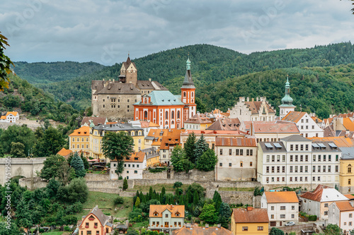 Panoramic view of famous medieval town of Loket,Elbogen, with colorful houses and stone castle above river,Czech Republic.Historical city centre is national monument.Travel architecture background photo