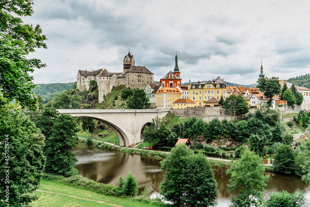 Panoramic view of famous medieval town of Loket,Elbogen, with colorful houses and stone castle above river,Czech Republic.Historical city centre is national monument.Travel architecture background