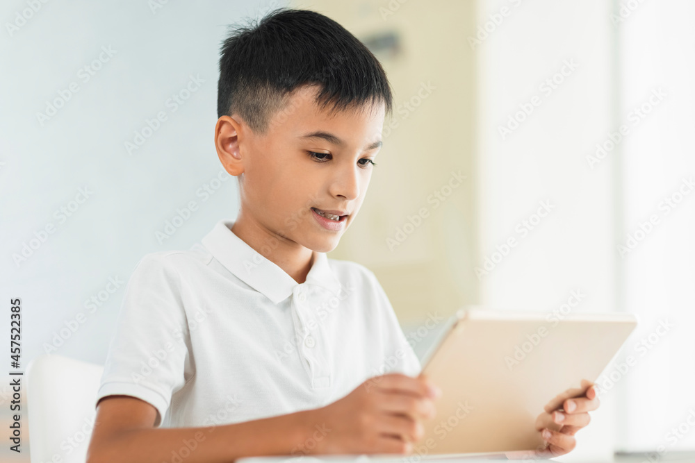 Boy looking at tablet.Study online.Watching video. Boy looking at tablet.Study online.Watching video.
