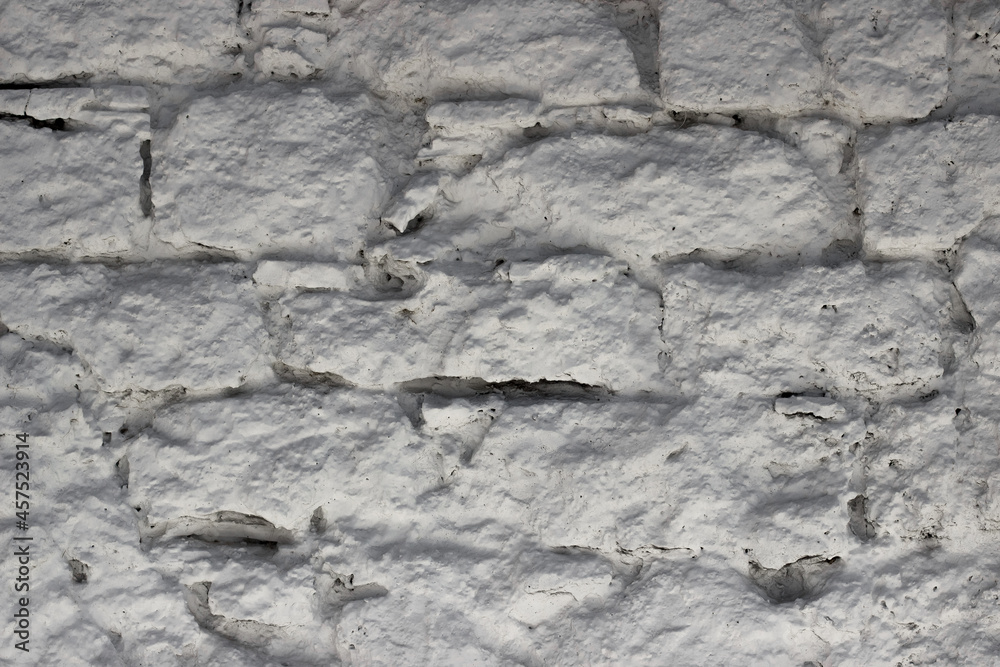 Fragment of the wall from natural stone painted with lime Fragment of the wall from natural stone painted with lime