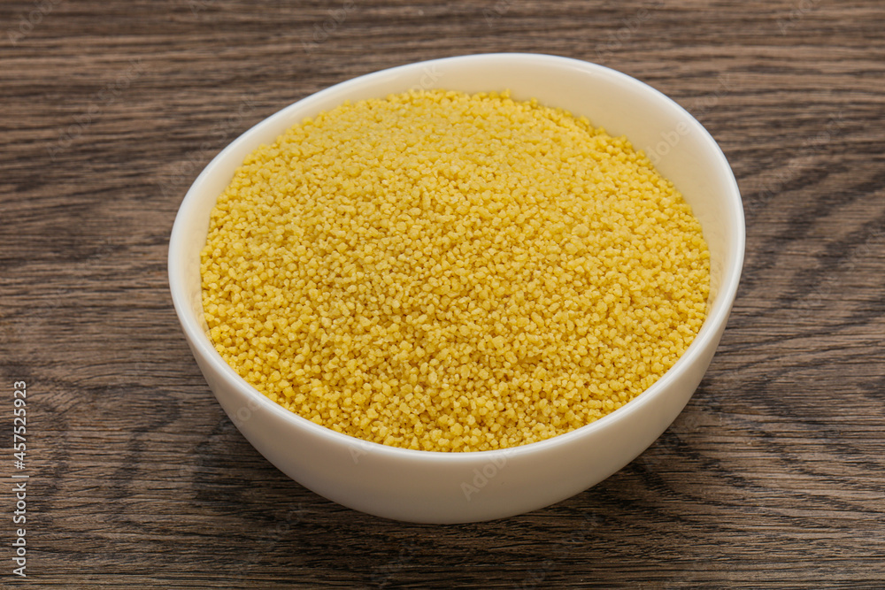 Raw cous cous heap in the bowl Raw cous cous heap in the bowl