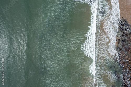 The huge surfing beach of Caswell Bay, on the South Wales Coast Path, at low tide photo