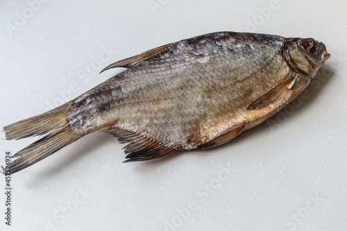 Dried salted fish close-up on white background.