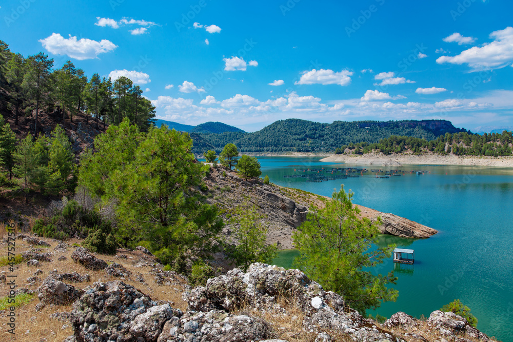 Beautiful Karacaoren turkish lake with mountains and cloudy sky reflections