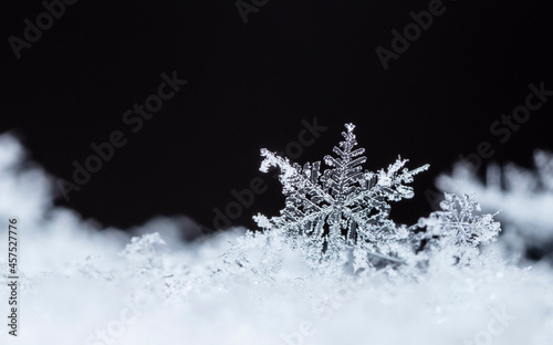 Snowflake on snow. Winter holidays and Christmas background