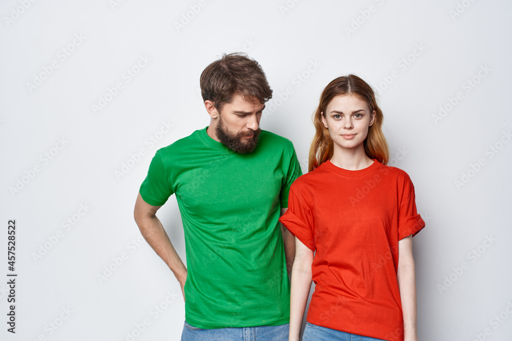 a young couple hug friendship colorful t-shirts family light background a young couple hug friendship colorful t-shirts family light background