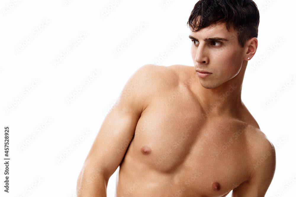sexy guy athlete with a pumped-up torso nude model light background