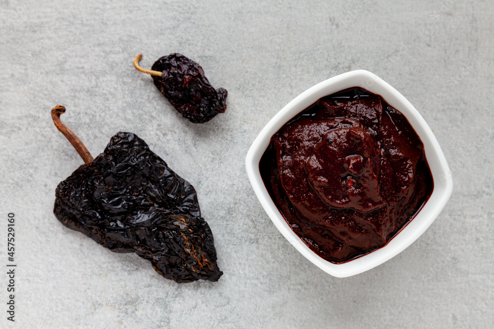 Adobo Sauce In Bowl Top View Dried Ancho Chili Next To Stock Photo   1000 F 457529160 PCmR31OX9hwbFrMs3r4obSNQMNbcOCSZ 