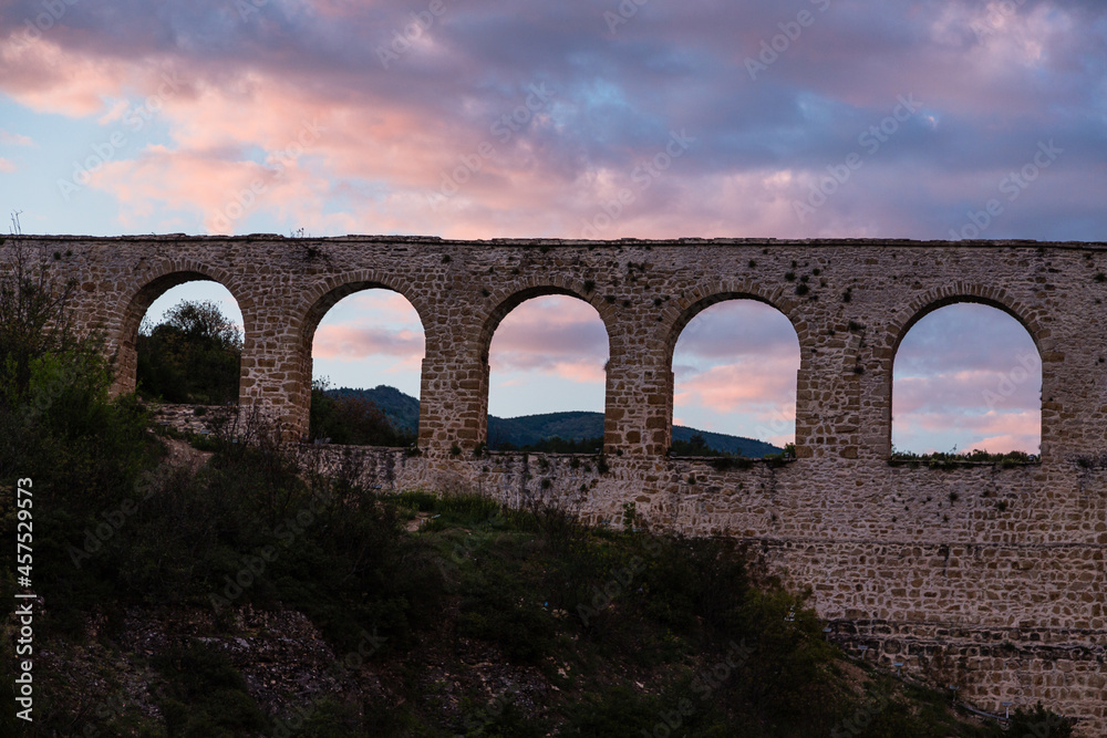 Fototapeta premium トルコ サフランボル近郊のインセカヤのトカトリ峡谷にある水道橋と夕焼けで染まった空
