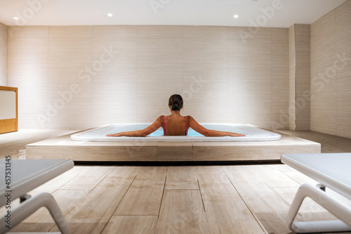 Fototapeta Naklejka Na Ścianę i Meble -  Woman relaxing in hot tub in spa