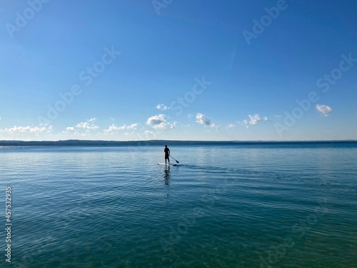 tranquil paddle boarder on calm lake