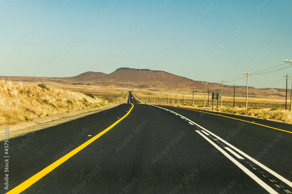 Road through beautiful karoo countrysides, rolling hills and meadows South Africa