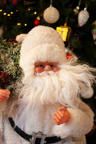 Santa claus under the christmas tree, bokeh, background, toys, merry christmas, happy new year. 2022. Lights, sparkles and glare, snow, Christmas decor, toys