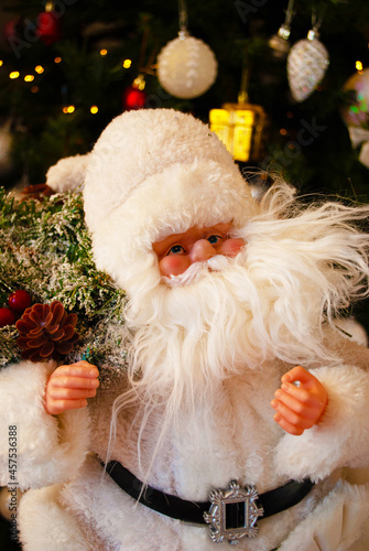 Santa claus under the christmas tree, bokeh, background, toys, merry christmas, happy new year. 2022. Lights, sparkles and glare, snow, Christmas decor, toys