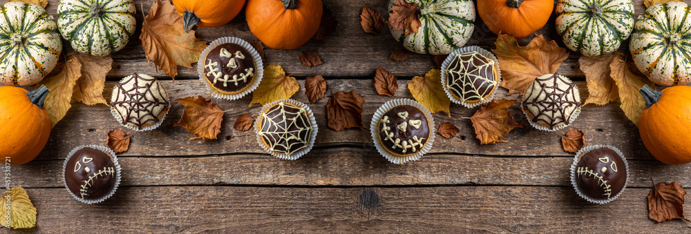 Funny Halloween cakes for party. Halloween background with pumpkin and cake. Autumn, Halloween, party concept. Long format with copy space Funny Halloween cakes for party. Halloween background with pumpkin and cake. Autumn, Halloween, party concept. Long format with copy space