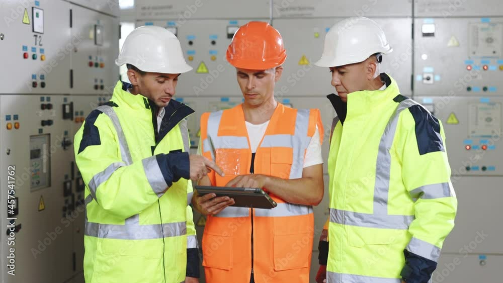 Professional engineering discuss inspecting with engineer team in clean room machinery factory area. Manager hand use tablet listenreport paper for internal audit Professional engineering discuss inspecting with engineer team in clean room machinery factory area. Manager hand use tablet listenreport paper for internal audit