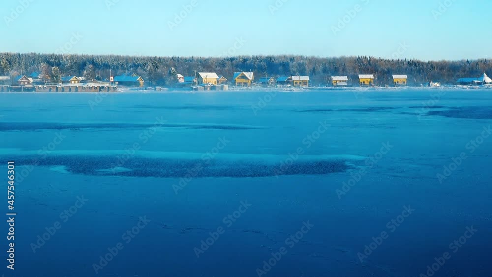 Beautiful, cold sunset on the winter, icy river. Air vapor spreads over the water in the rays of the setting sun. Beautiful, cold sunset on the winter, icy river. Air vapor spreads over the water in the rays of the setting sun.