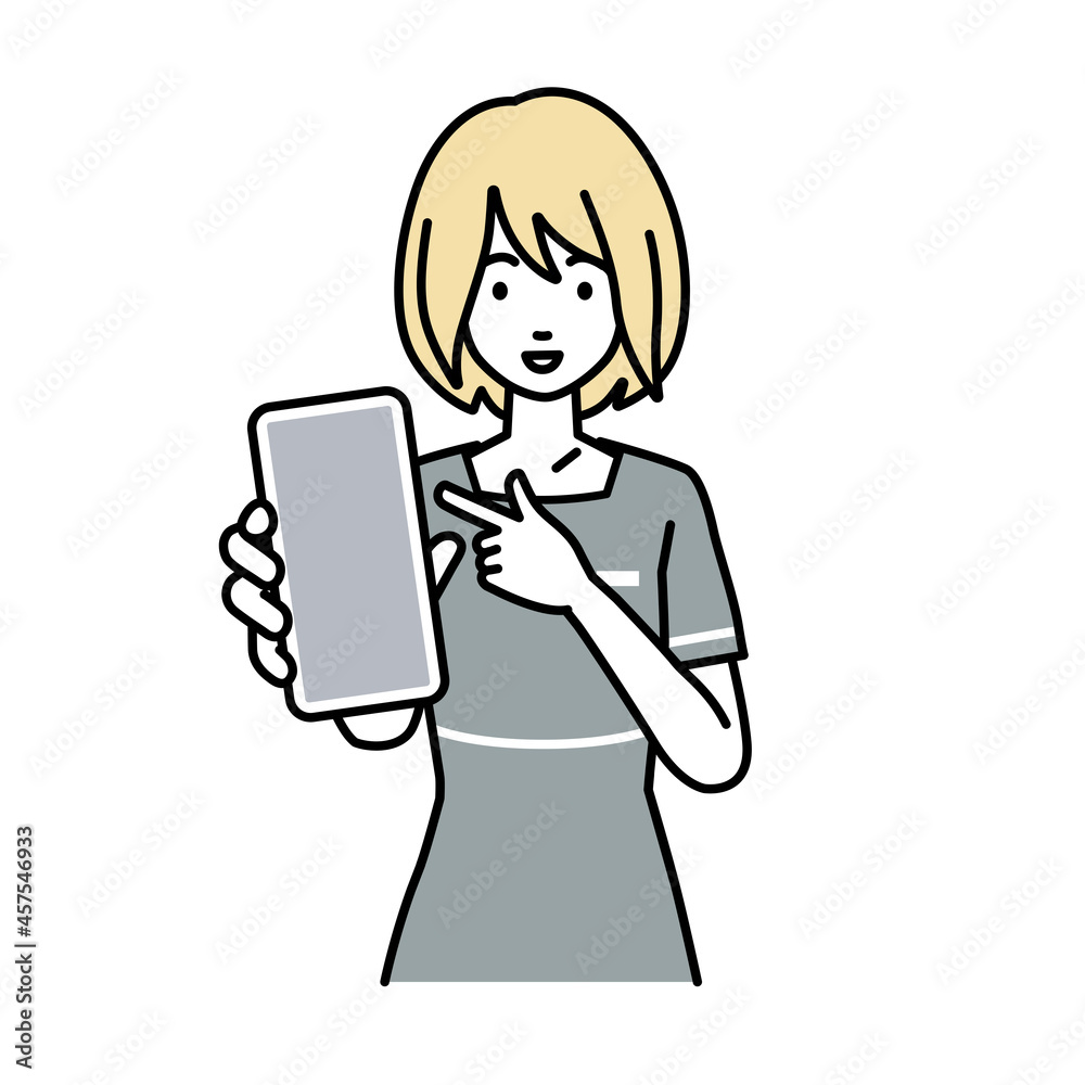 立ってスマートフォンを指差してこちらに向けて見せているエステ店員の女性