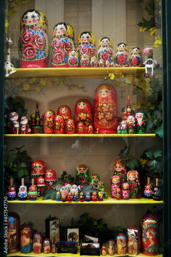 Wooden matryoshka dolls in glass showcase cabinet of local souvenirs gifts toys shop for czechia people and foreign travelers buy shopping at old town at Praha city in Prague, Czech Republic