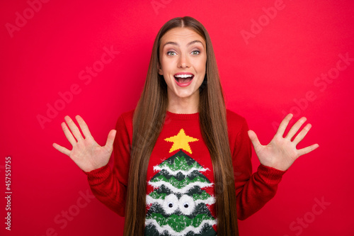 Photo of excited crazy amazed lady wow x-mas sale reaction wear ugly pullover isolated red color background