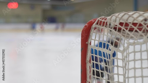 Children playing ice hockey in an arena. Young hockey players practising. photo