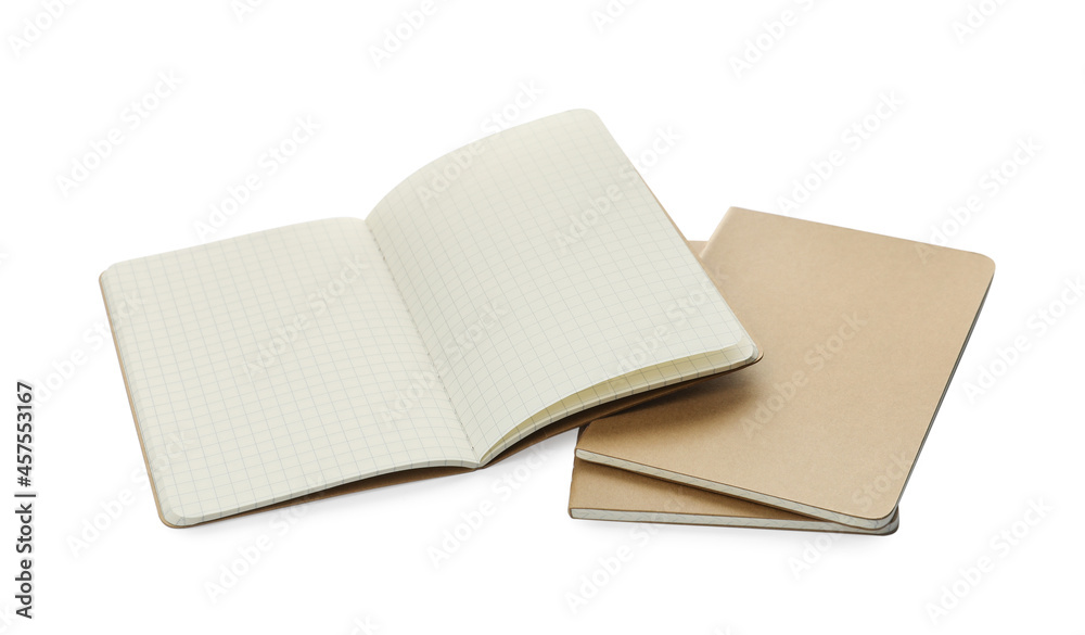 Stylish open notebook with blank sheets and kraft planners on white background Stylish open notebook with blank sheets and kraft planners on white background