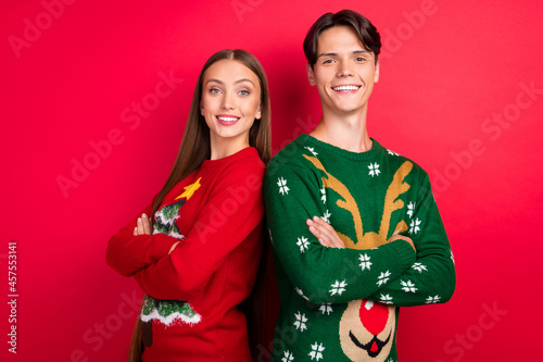 Photo of self-assured two friends folded arms look camera posing wear ugly sweater isolated red color background