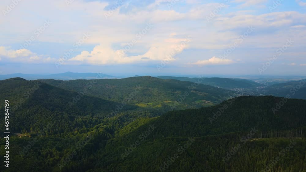 Aerial view of mountain hills covered with dense green lush woods on cloudy evening. Aerial view of mountain hills covered with dense green lush woods on cloudy evening.