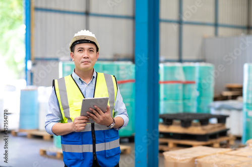 Portrait of asian man worker in warehouse. logistic and business import export.