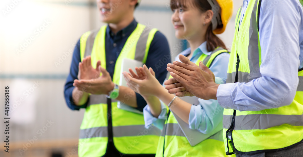 Professional Engineering and worker team congratulated success by applaud at industrial manufacturing factory.