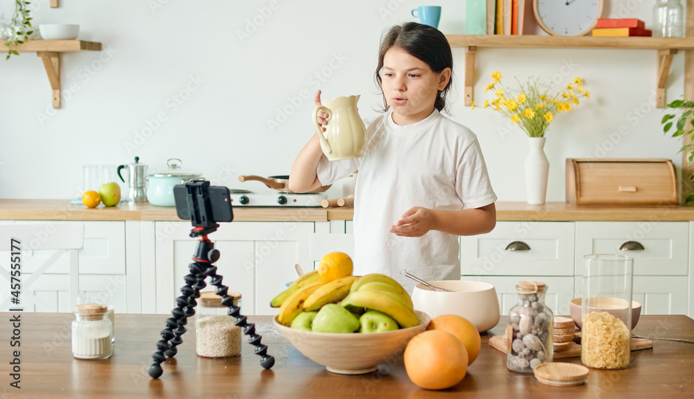 A Girl Vlogger Records Video Content for a Culinary Blog. A Cheerful Girl Shares Her Secrets on the Air of a Culinary Video Blog. Communication, Healthy Eating, Childhood, Hobbies. Webinar Concept