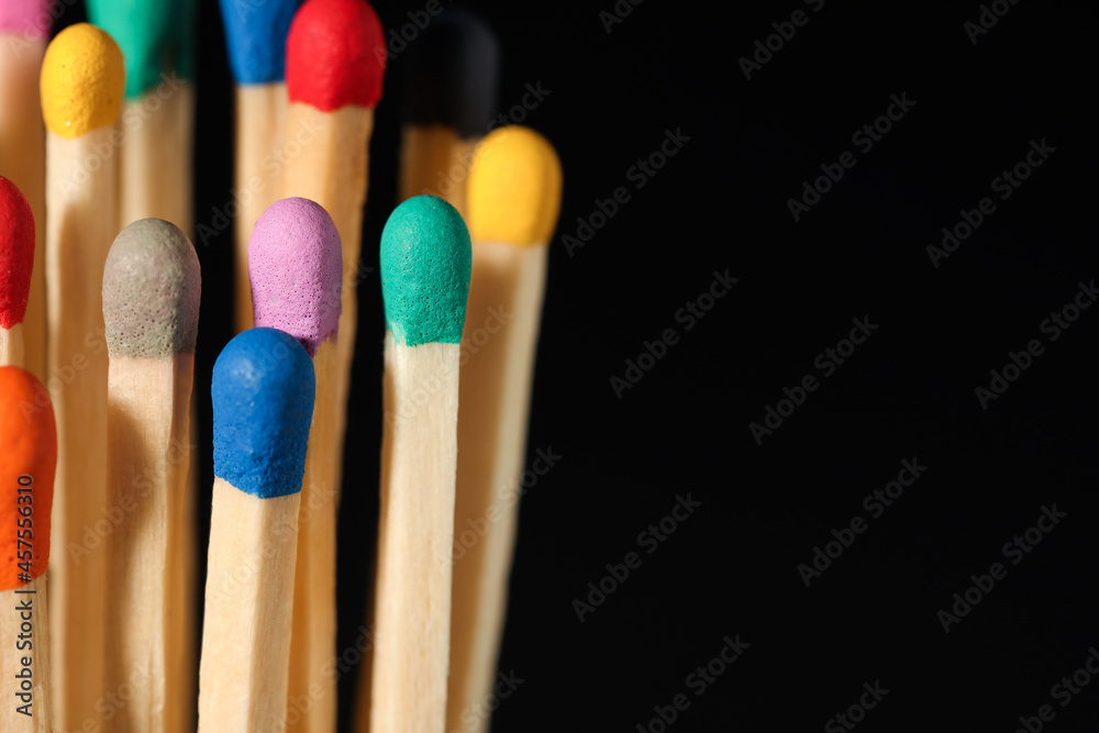 Matches with colorful heads on black background, closeup. Space for text Matches with colorful heads on black background, closeup. Space for text