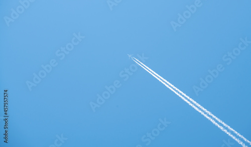 airplane flying high in the blue sky