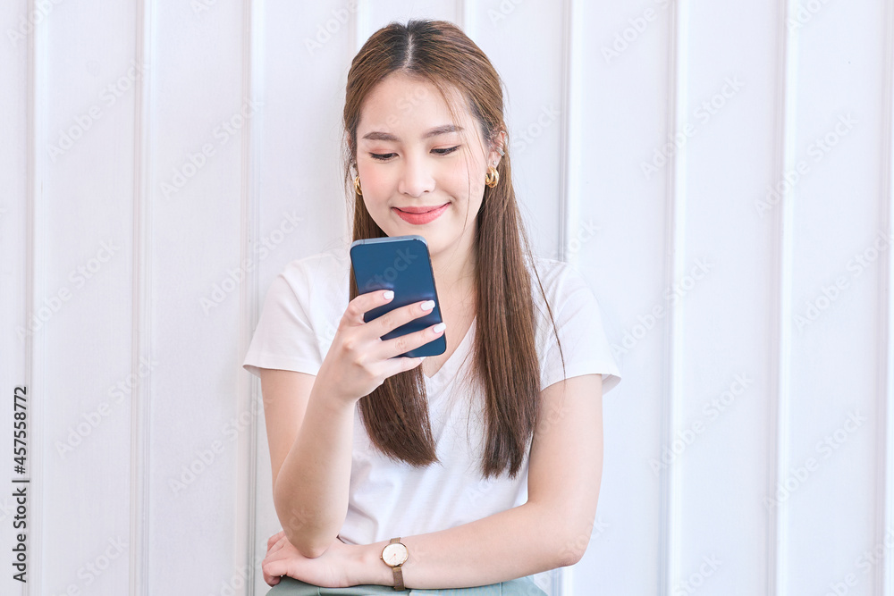 Happy woman use phone and smile at home Happy woman use phone and smile at home