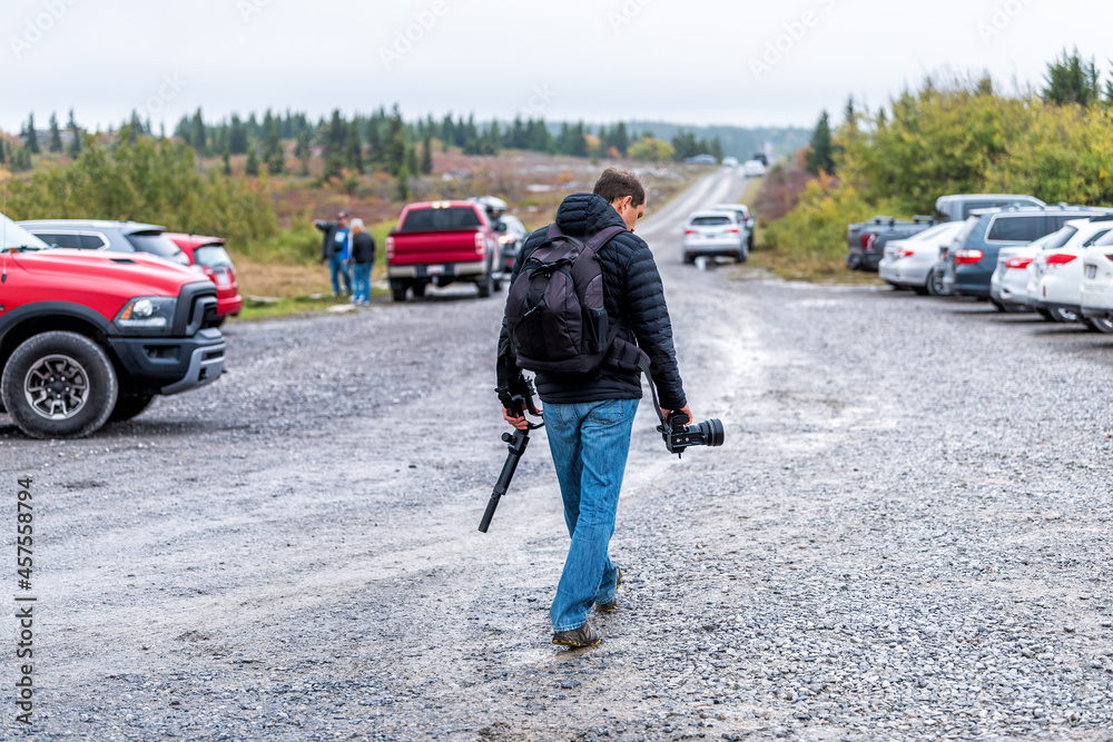 Dolly Sods Bear Rocks trail with parking lot and cars parked in West Virginia fall season and photographer people hiking man with tripod camera and backpack