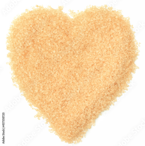 Brown sugar in shape of heart. White background