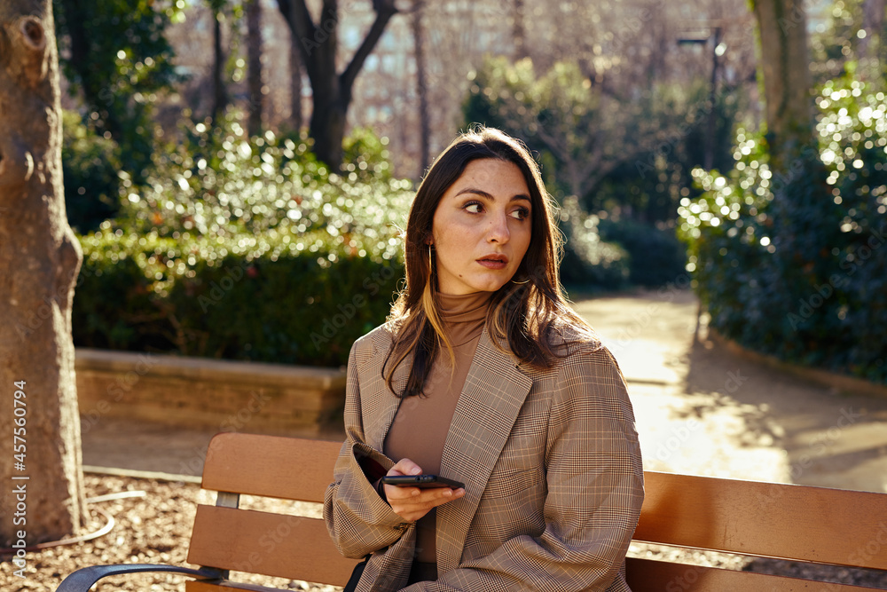 A perplexed lady sitting on a parking A perplexed lady sitting on a parking