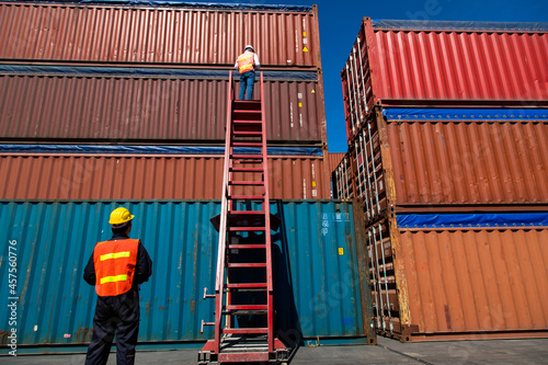 Marine and carrier insurance concept. Foreman control loading Containers box at shipping port. Business logistic Import and export concept.