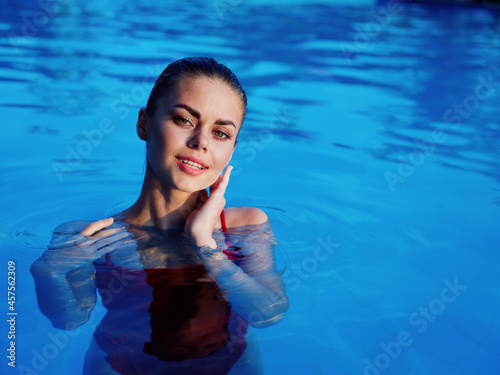woman in red swimsuit in the pool luxury nature relaxation