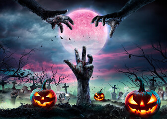 Zombie Hands Rising Out Of A Graveyard With Full Moon And Halloween Pumpkins