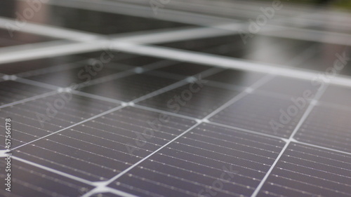 Close-up of modern photovoltaic solar battery panels. Ecology and environment protection concept. Renewable green energy. Solar panels close-up. Solar panels slow motion. Solar panels moving shot.
