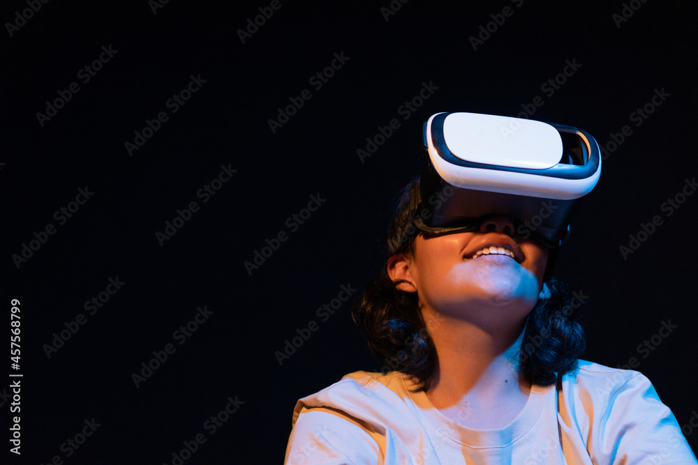 Young woman wearing virtual reality glasses for the first time.