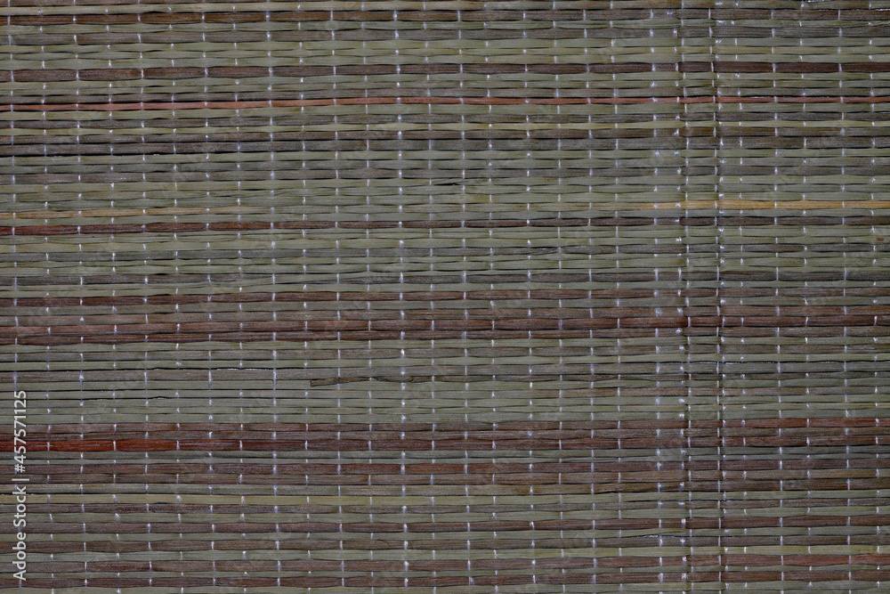 Woven mat made of natural bamboo.Background. Texture for the background. Woven mat made of natural bamboo.Background. Texture for the background.