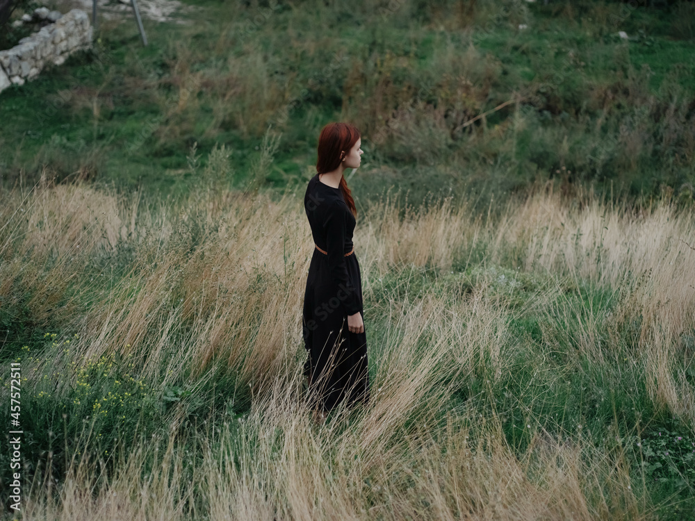 Red-haired woman mountains nature grass stroll landscape