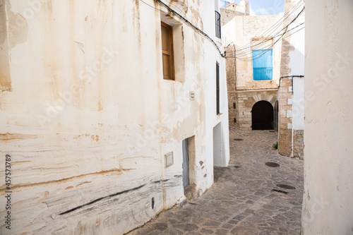 The architecture of the island of Ibiza. A charming empty white street in the old town of Eivissa © romeof