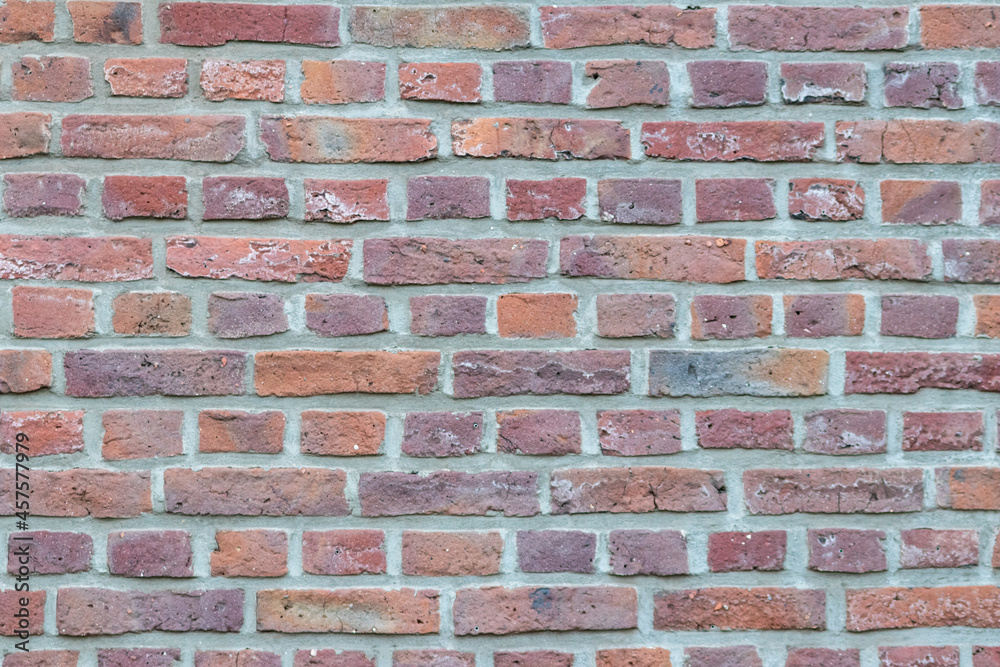 Massive stone wall with rough rocks like a castle wall with different bricks as natural background and rocky wall of ancient times shows solid bricks of stones as vintage texture for granite minerals Massive stone wall with rough rocks like a castle wall with different bricks as natural background and rocky wall of ancient times shows solid bricks of stones as vintage texture for granite minerals