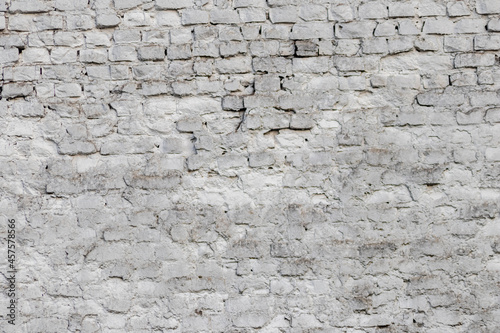 Solid wall with white bricks in vintage style as grey stonewall background or wallpaper with urban house architecture seamless aged in rectangle tiled stone texture and modern rough surface material