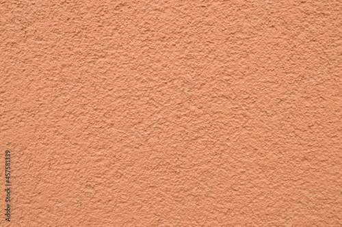 Foto grungy orange background. Plastered building background.