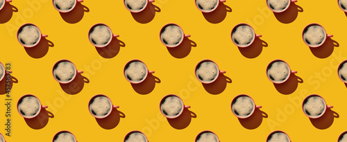 Pattern of coffee mugs on yellow pastel background